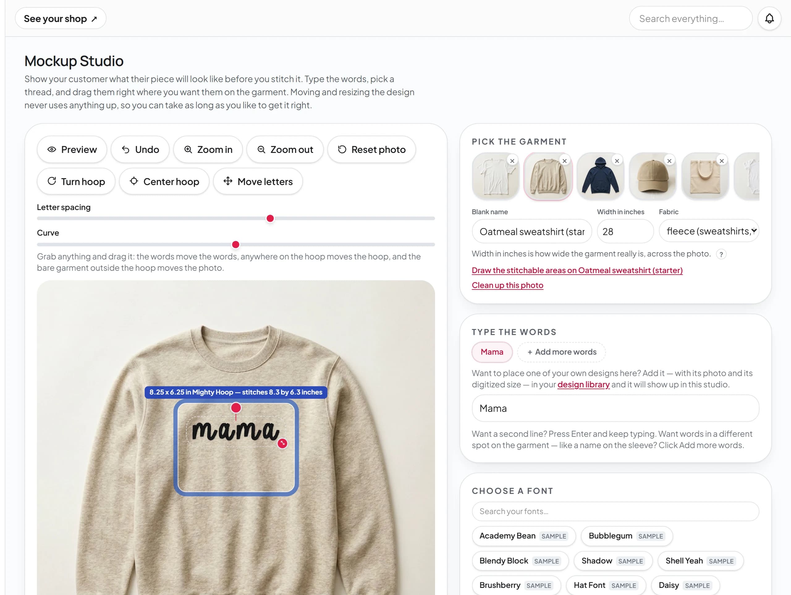 The Mockup Studio: the word mama placed inside a real hoop on an oatmeal sweatshirt photo, with the garment picker and font list beside it.